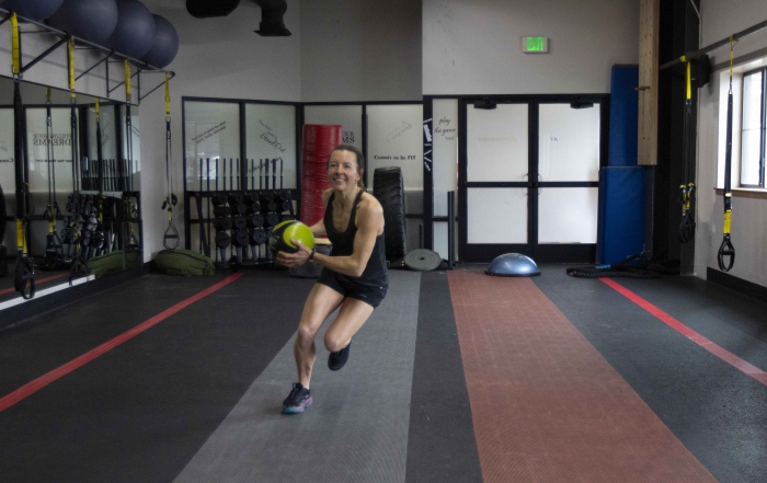 PSIA Alpine Team Member Heidi Ettlinger does a skate lunge with a medicine ball