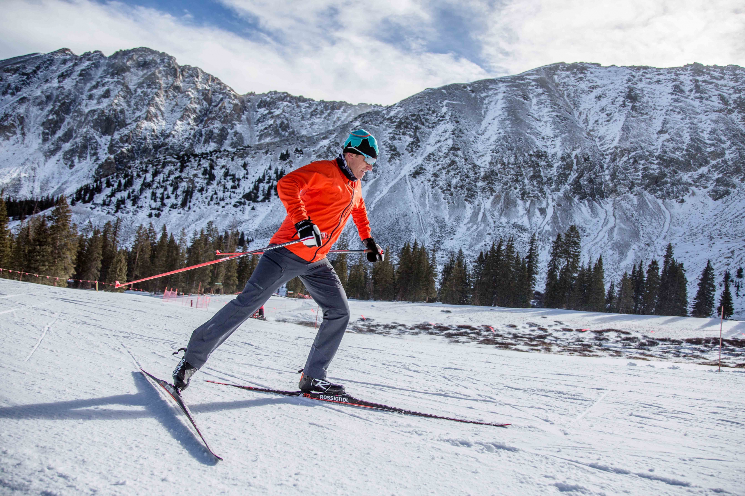 PSIA-AASI National Team member Greg Rhodes skate skis in front of the A-Basin East Wall