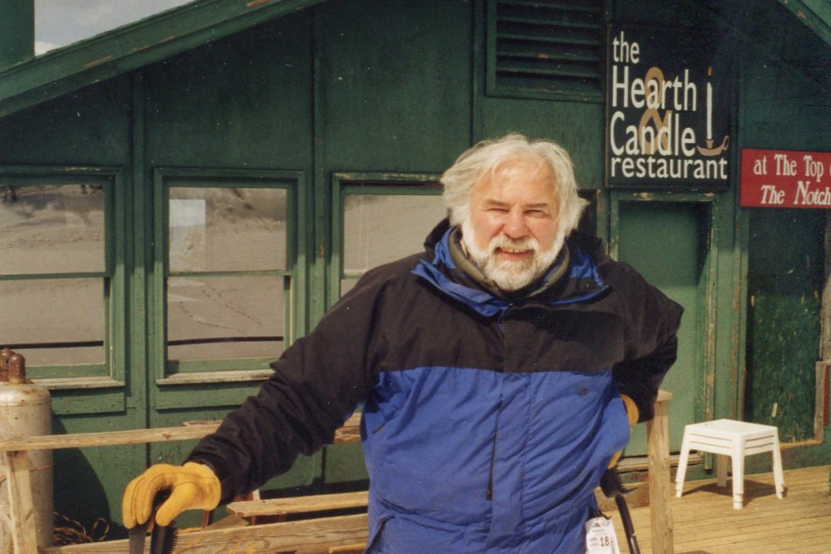 Carl Ettlinger II on skis on front of a hut