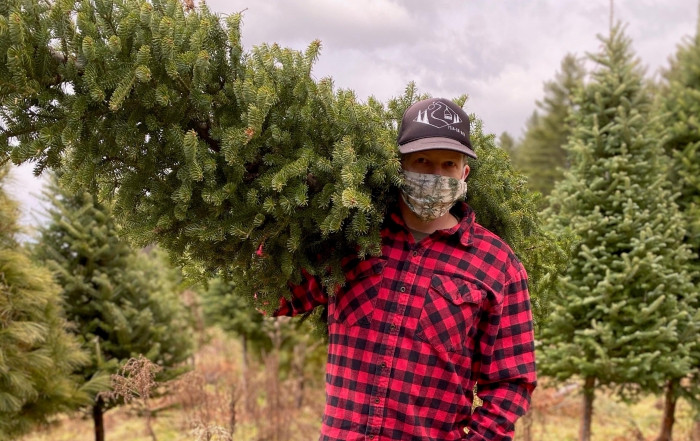 Nate Gardener holds a Christmass tree