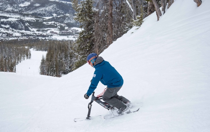 A sno-go rider descends the ski slope