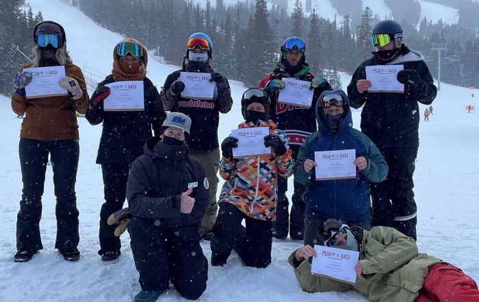 Rocky mountain AASI Level I snowboard instructors hold their certificates