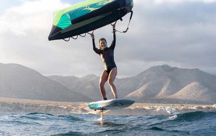 A women windsurfs on a slingshot board