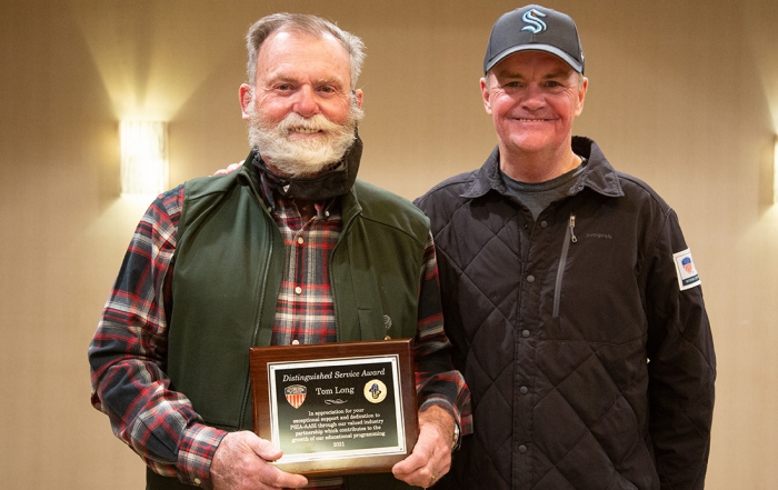 Robin May presents Tom Long the Distinguished Service Award.