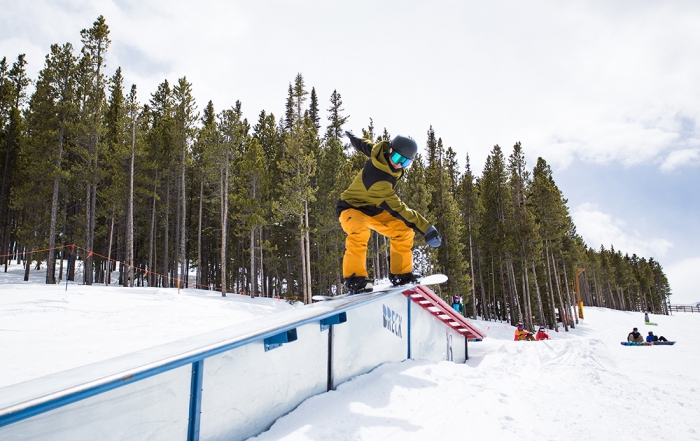 AASI Snowboard Team member slides a rail on his snowboard