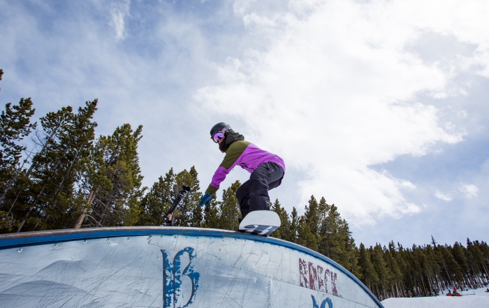 Christina Bruno snowboards a rainbow rail