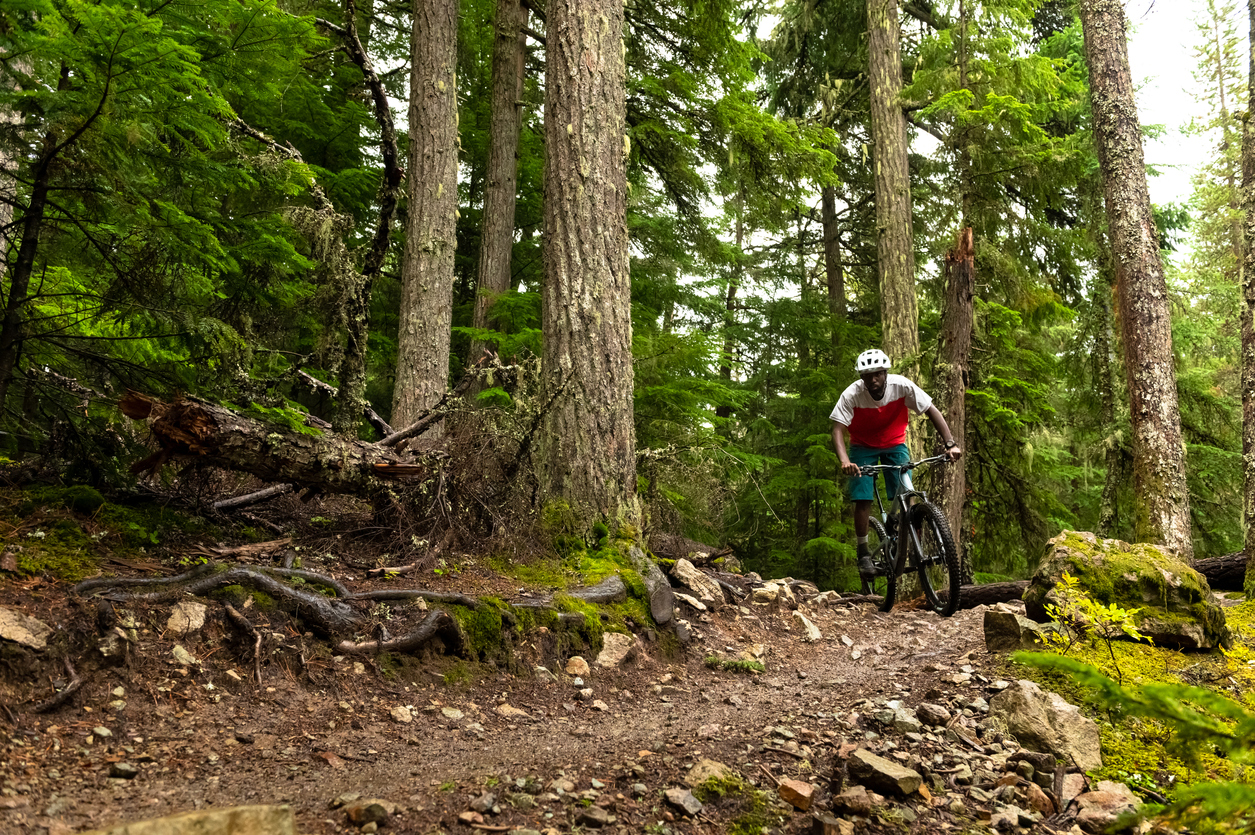 African American athlete riding a mountain bike. Best biking destinations in North America. Living an active lifestyle.