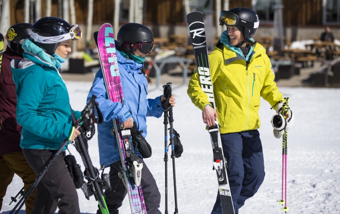 Female instructor walking with ski students