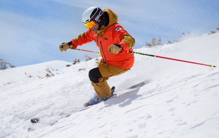 PSIA-AASI National Team Head Coach Jeb Boyd skis down a steep slope.