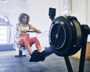 Woman Practicing Fitness In Summer on Rowing Machine for Injury Prevention for Winter
