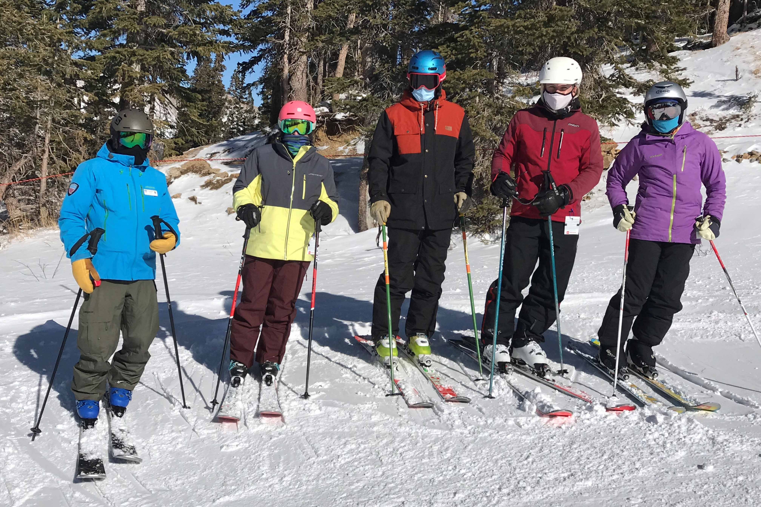 Skiers in masks at a ski clinic