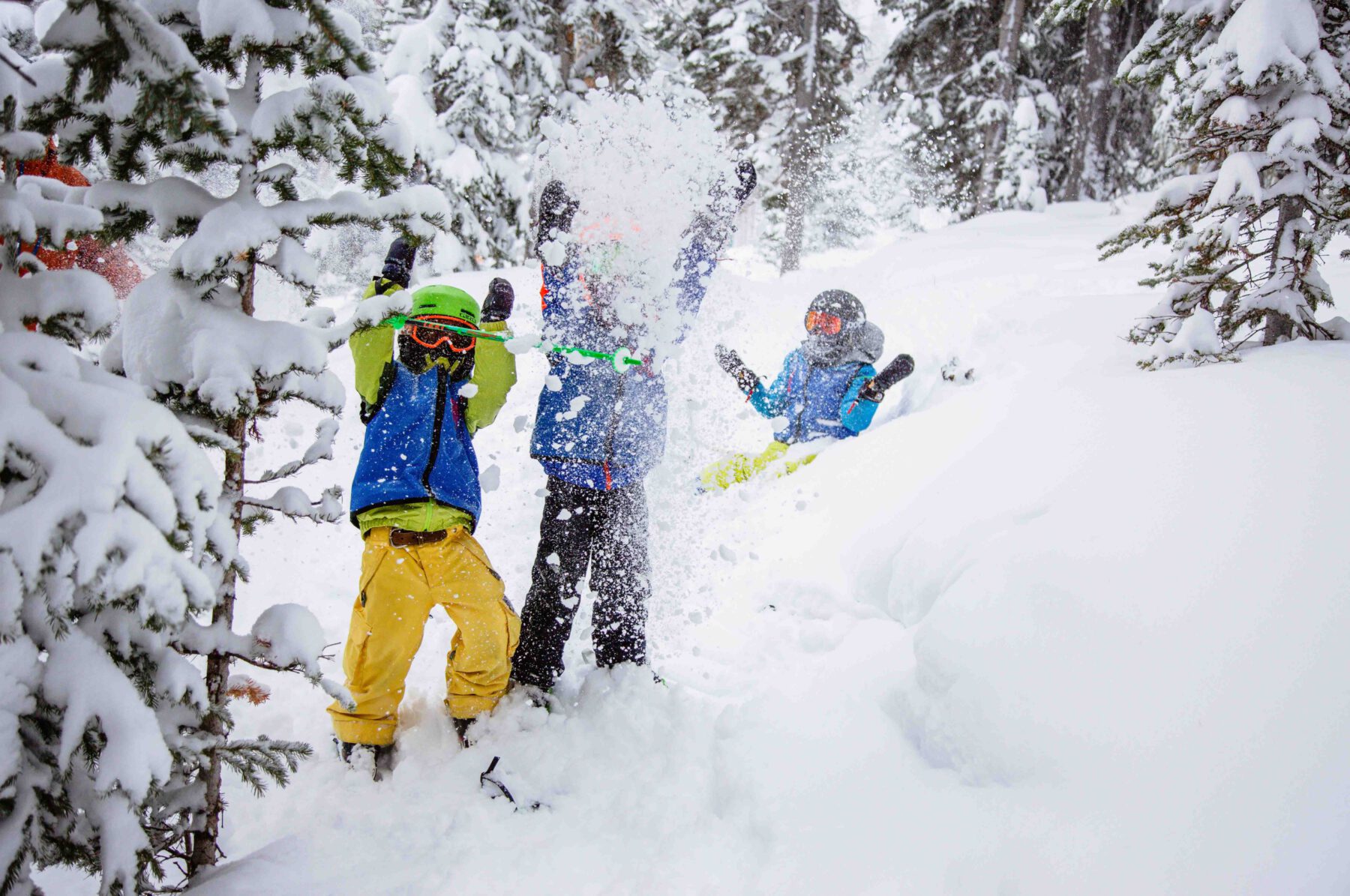 Children play in the powder during a ski school lesson