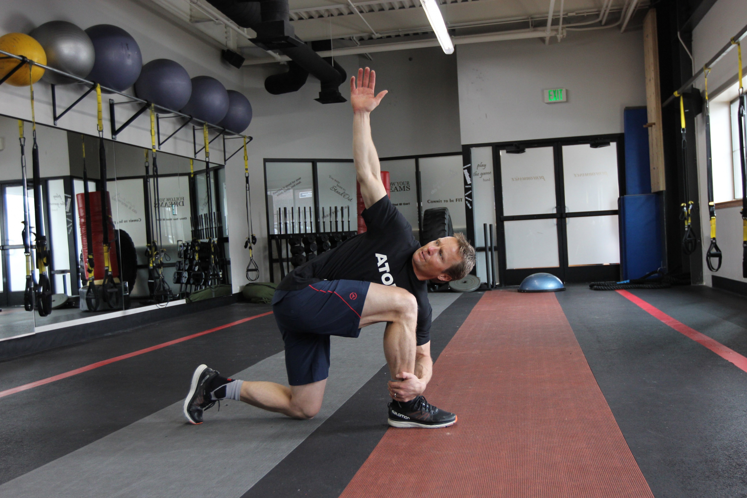 Daron Rahlves does a half kneeling windmill at the gym