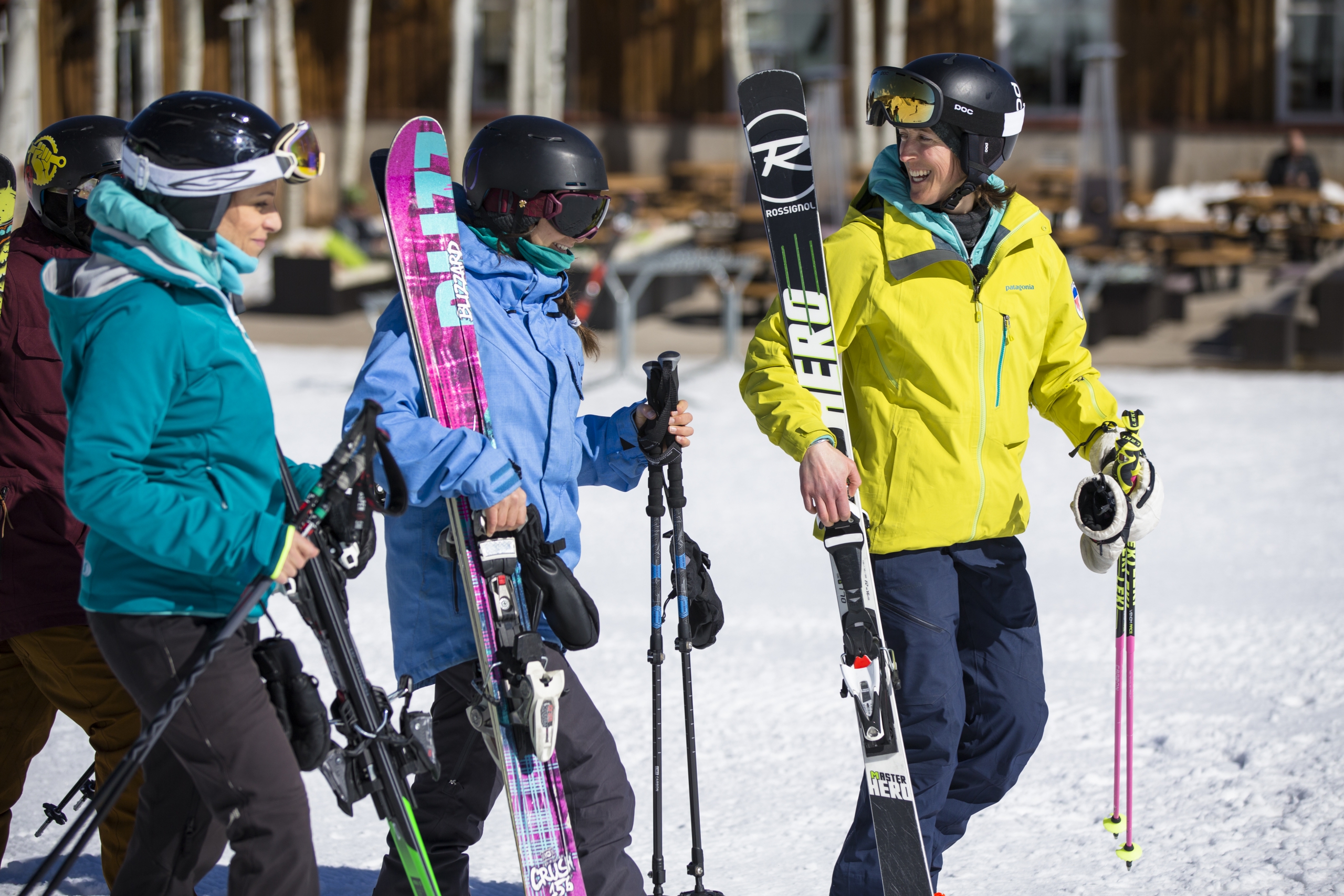 Female instructor walking with ski students