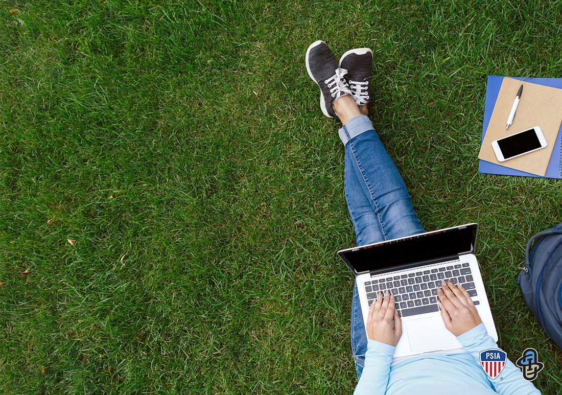 Working remote online with computer under tree during summer and continue education