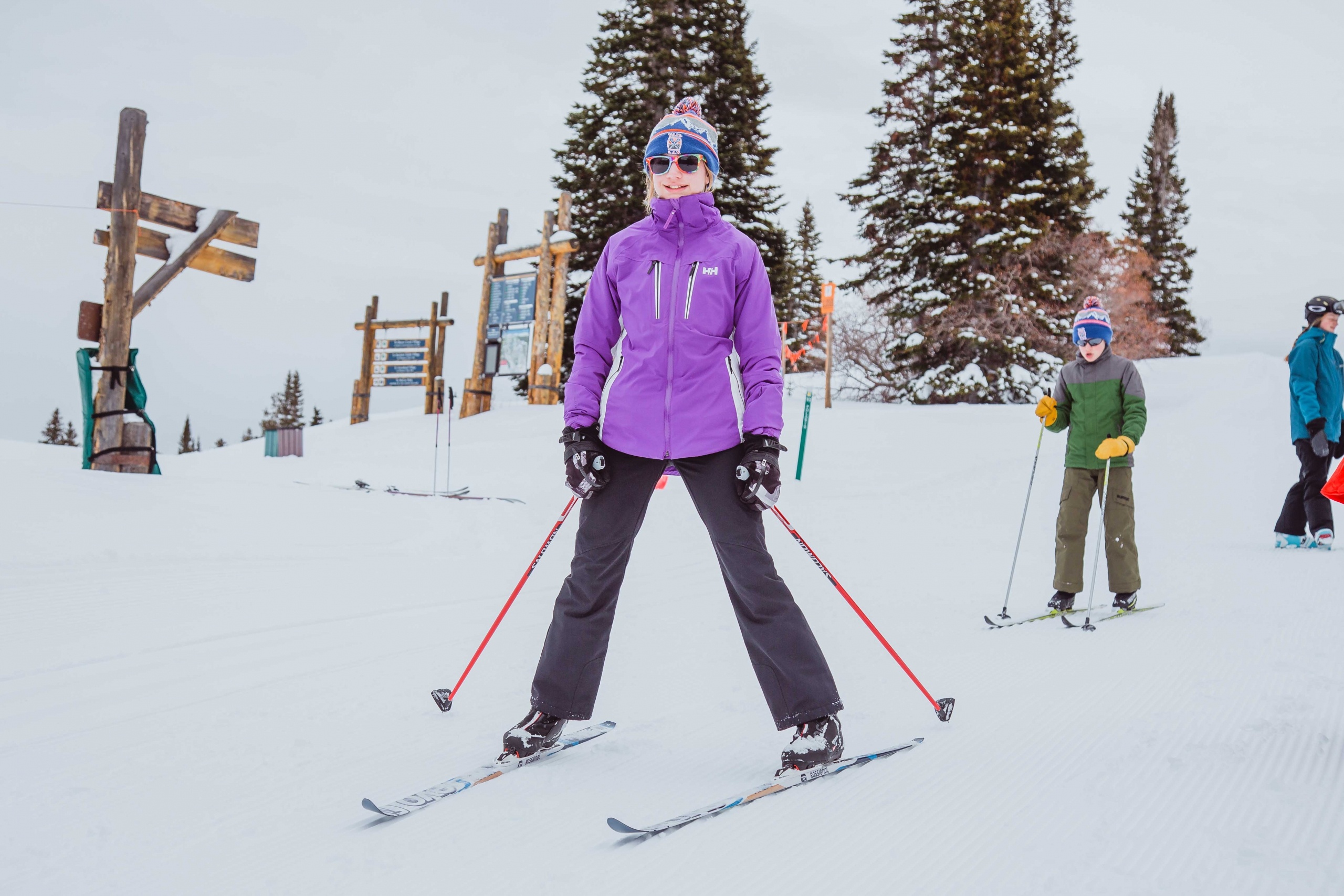 Two kids cross country ski