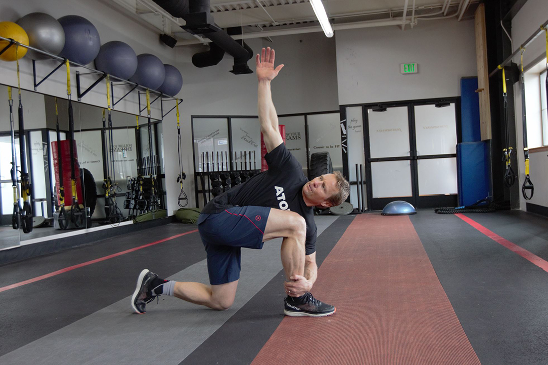 Daron Rahlves does a half kneeling windmill at the gym