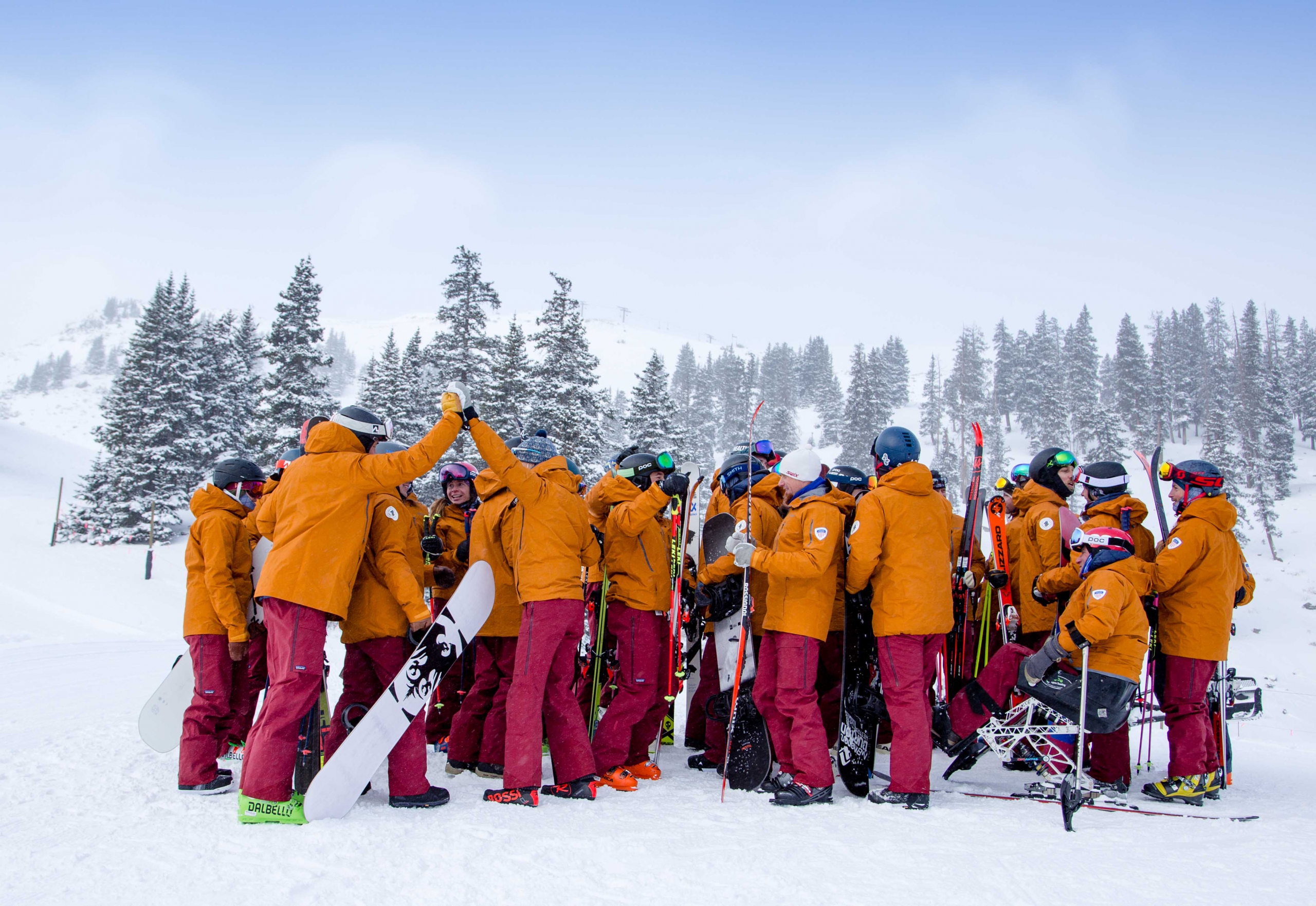 The PSIA-AASI National team stands together celebrating together