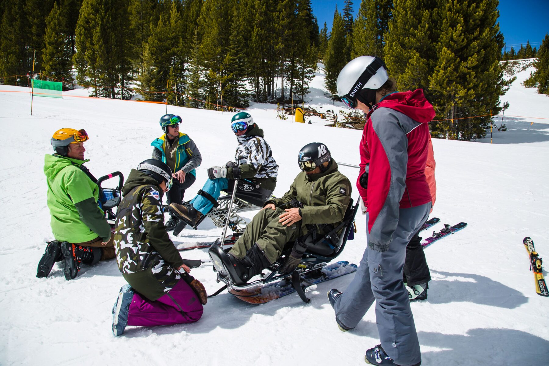 Group of adaptive skiers and snow instructors