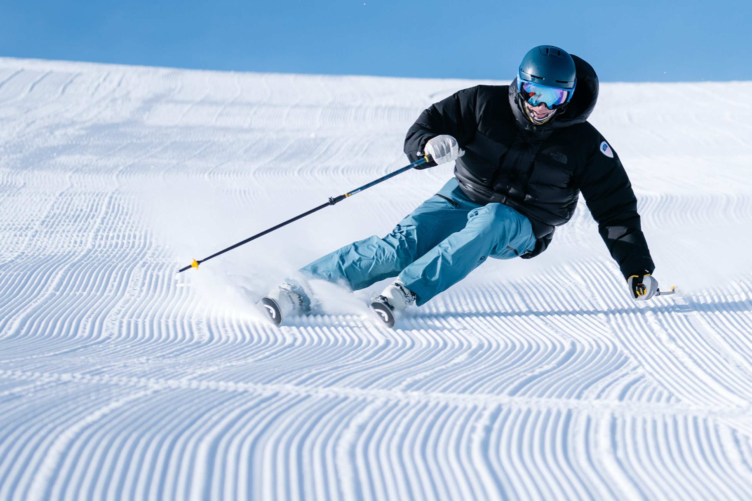 Skier carving groomed snow