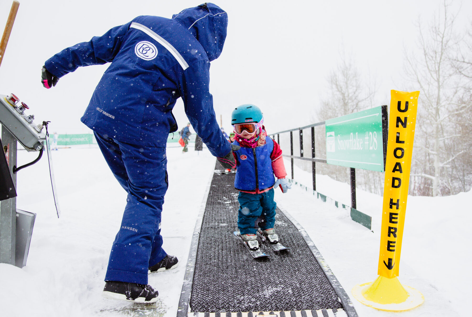 ski instructor with small child on skis