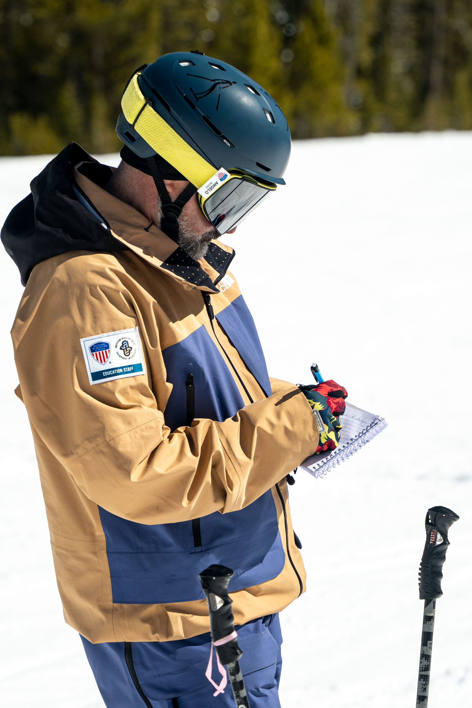 Ski instructor taking notes during a lesson