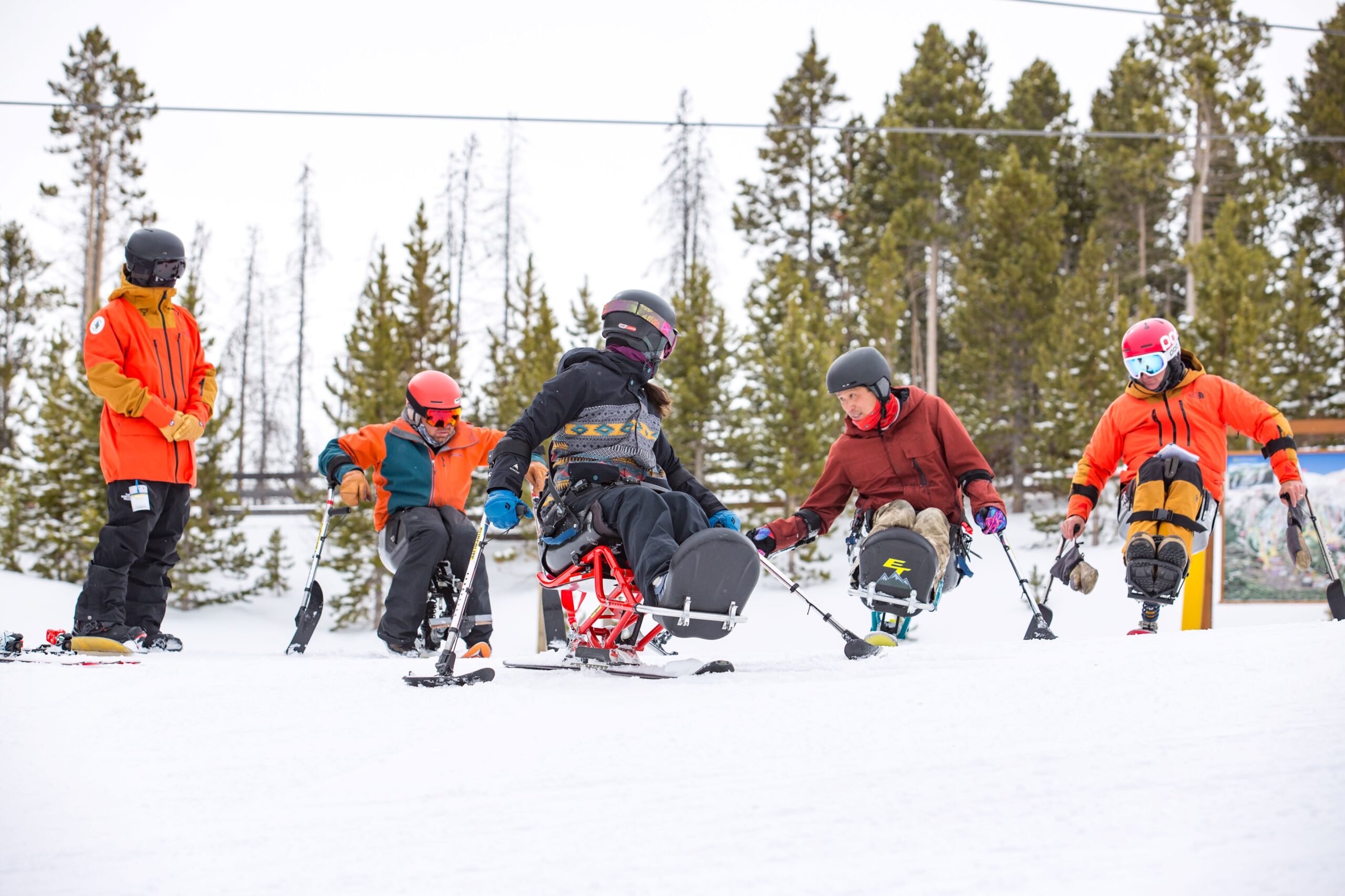 Group of adaptive skiers on snow.