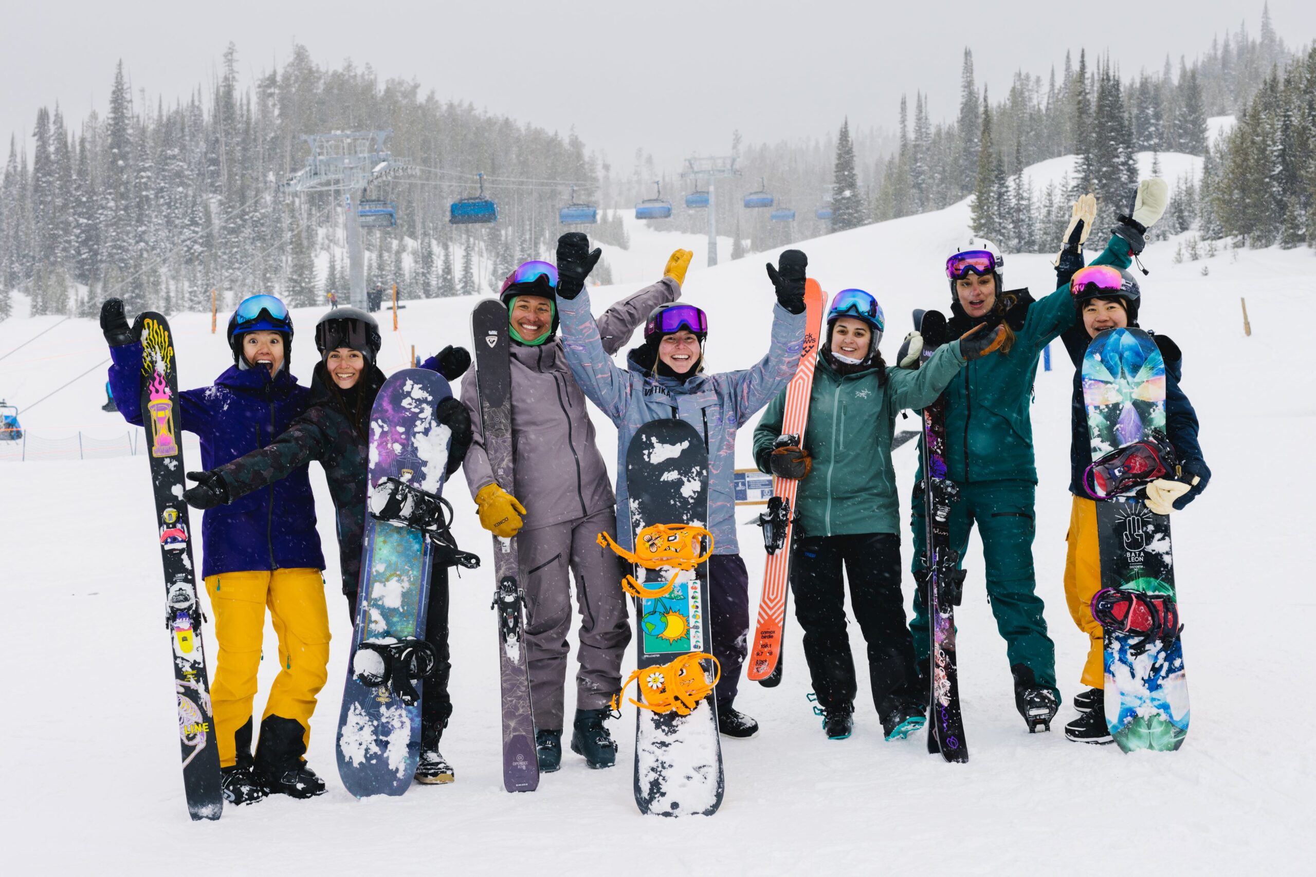 Group of women skiers and snowboarders.